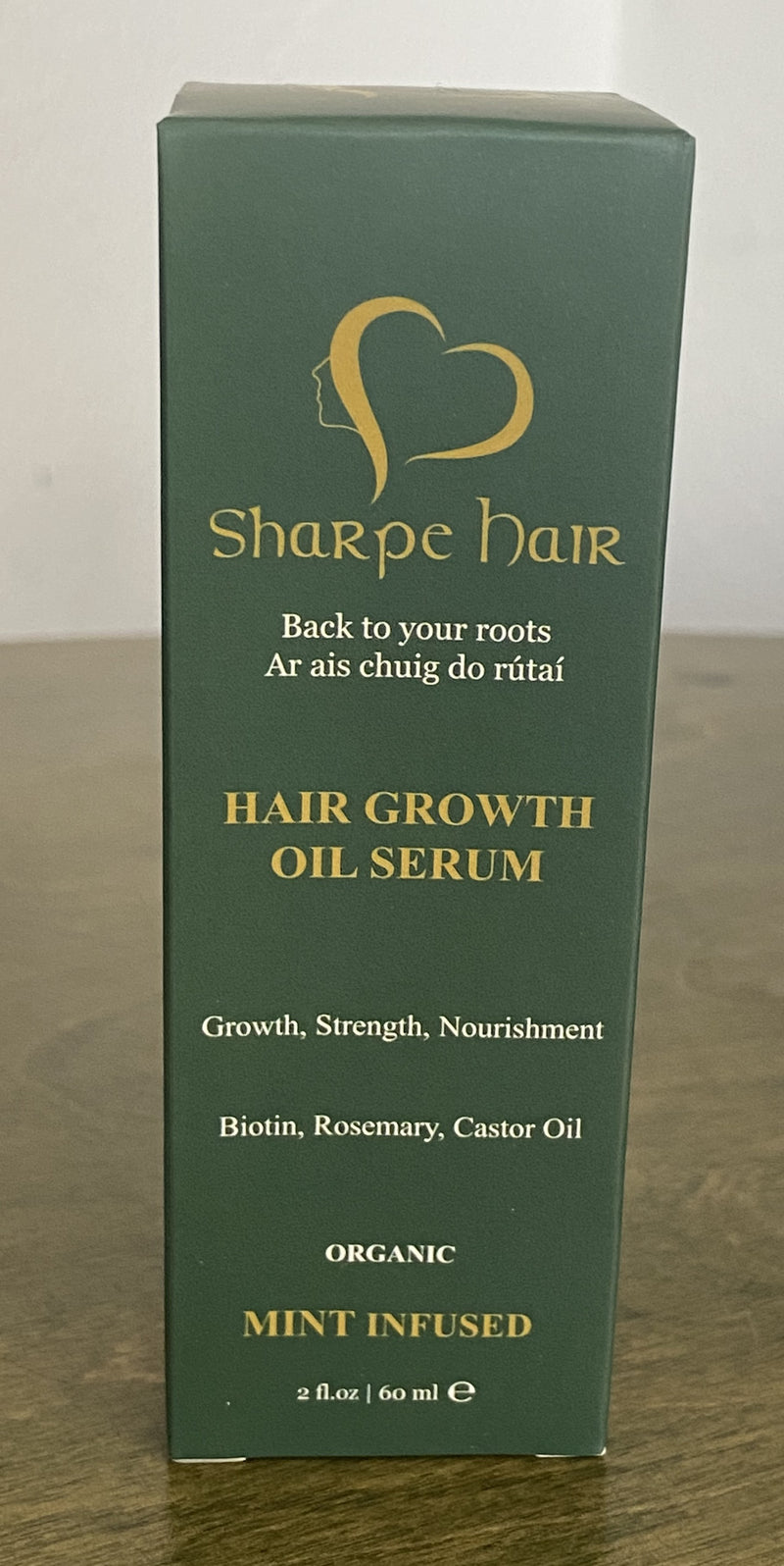 A bottle of Sharpe Hair Growth Oil Serum with the label showing the brand name, product name, and organic unscented indication.